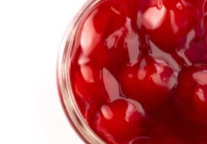 A Glass Canning Jar Filled with Cherry Pie Filling Isolated on a White Background A Glass Canning Jar Filled with Cherry Pie Filling Isolated on a White Background