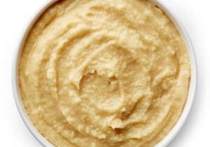 Bowl of homemade hummus Bowl of homemade hummus isolated on white background from top view